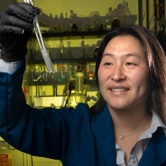 Ting Xu in lab looking at samples