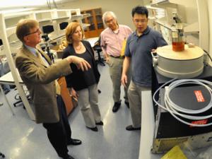 People in lab looking at instruments
